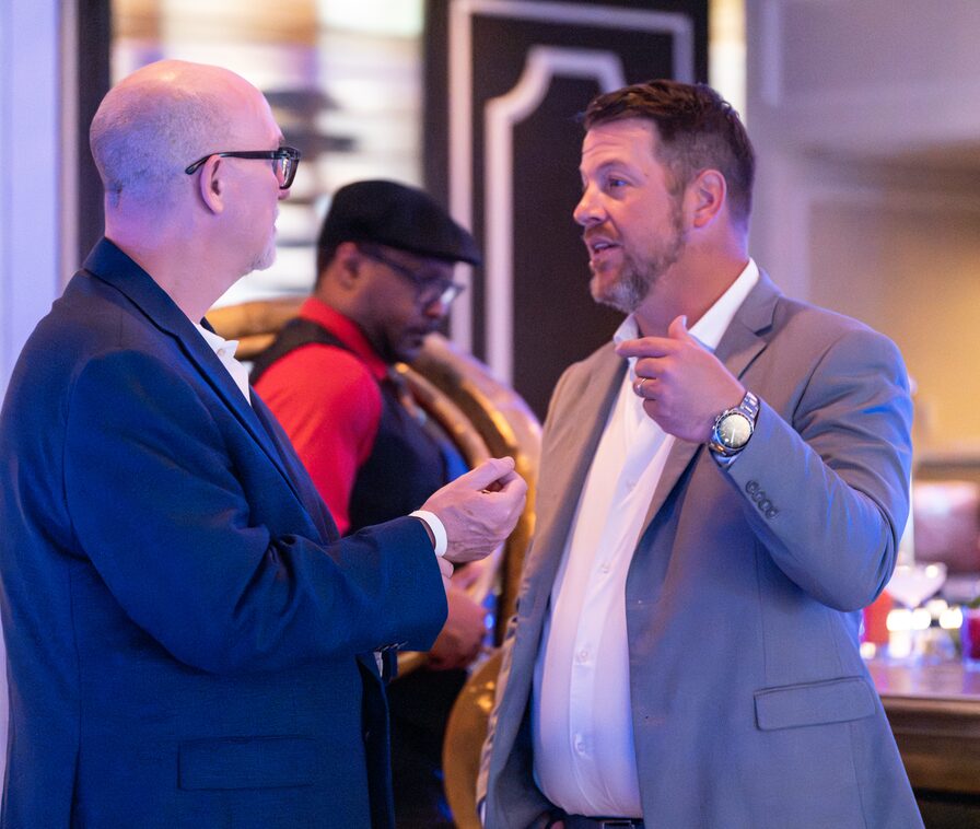 Two Updater colleagues in conversation at a company event