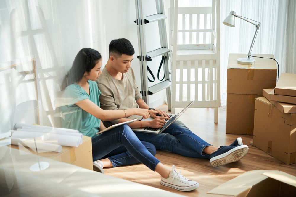 Couple with a computer and moving boxes