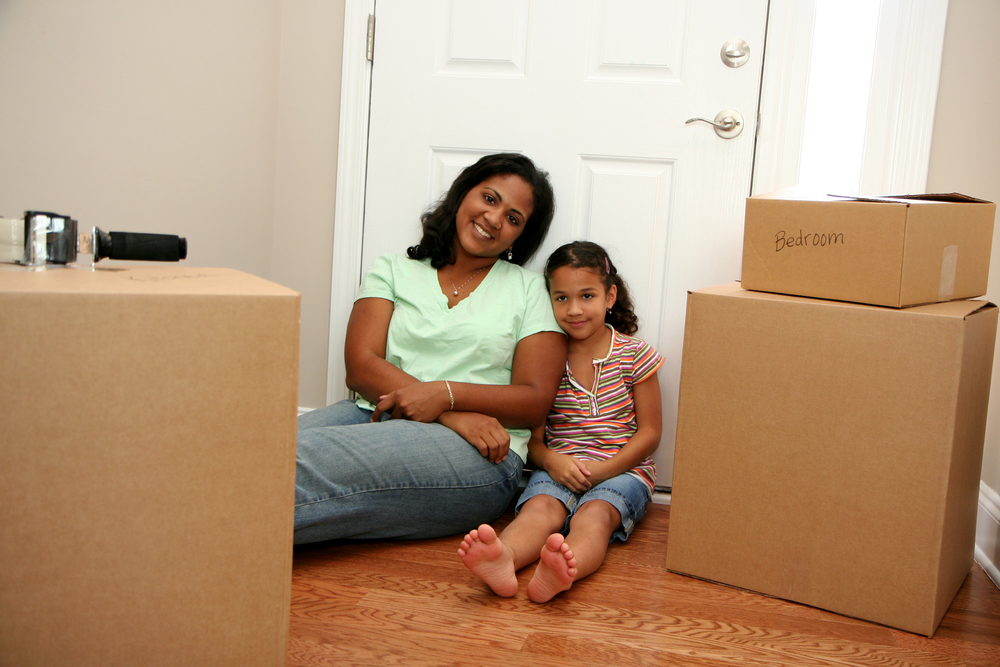 Mom and daughter surrounded by moving boxes
